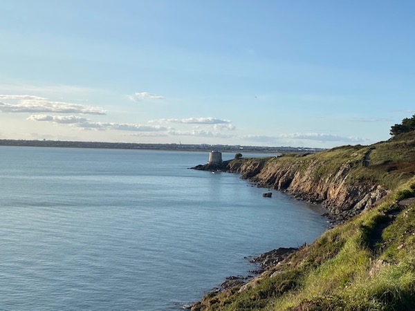 View from Howth cliff walk with sea and Martello Tower on September afternoon