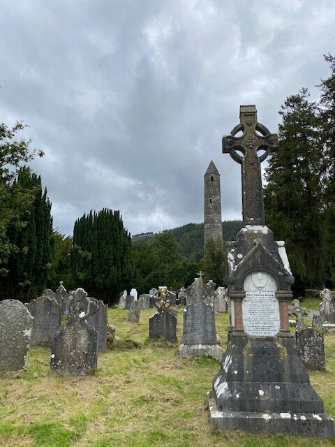 Glendalough medieval cemetery with round tower at the back